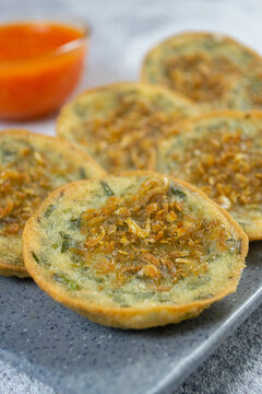 Indonesian street food Bakwan Pontianak topped with dried shrimp or udang rebon, served on a grey platter