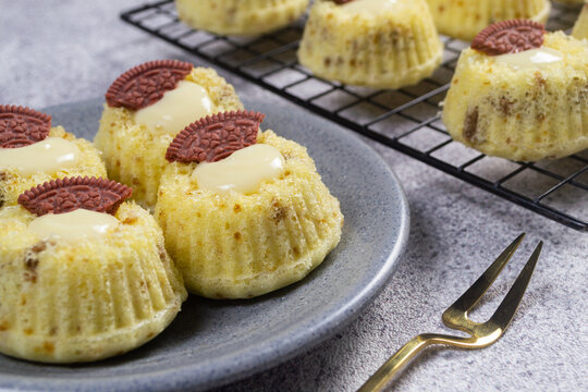 Steamed sponge cakes or bolu kukus topped with creamy white vla filling and red oreo cookies