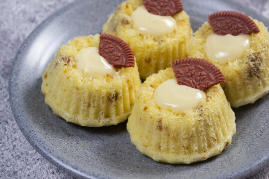 Steamed sponge cakes or bolu kukus topped with creamy white vla filling and red oreo cookies