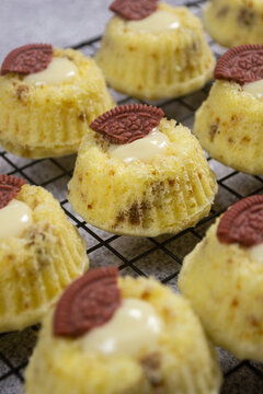 Steamed sponge cakes or bolu kukus topped with creamy white vla filling and red oreo cookies