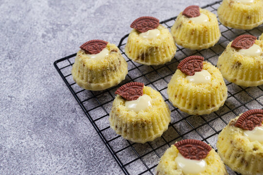 Steamed sponge cakes or bolu kukus topped with creamy white vla filling and red oreo cookies