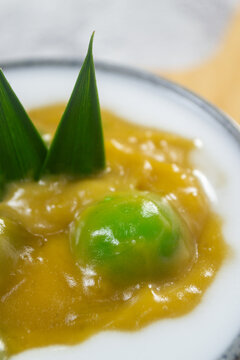 Indonesian traditional javanese sweet dessert Bubur Candil in a ceramic bowl garnished with pandan leaf