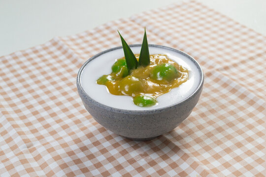 Indonesian traditional javanese sweet dessert Bubur Candil in a ceramic bowl garnished with pandan leaf