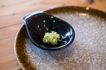Green wasabi sauce or paste in black bowl © Dontree