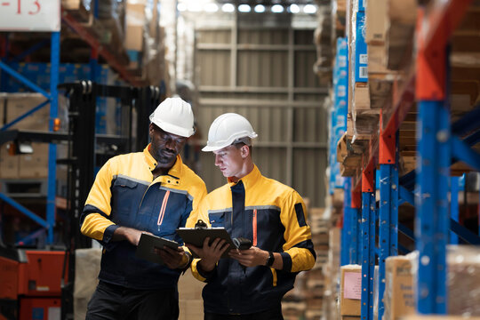 Team of warehouse worker manage inventory, process incoming and outgoing stock, organizes and fulfill orders inside storage or distribution facility