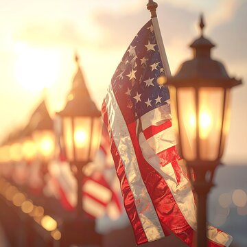 American flags waving on street lamps at sunset.