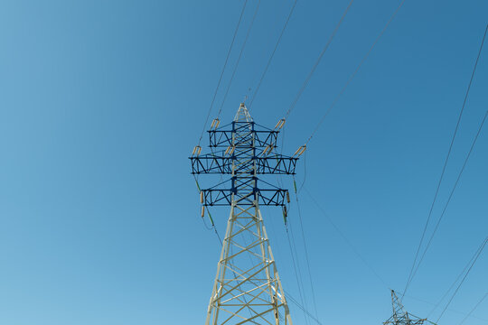 Communication tower standing tall against the sky, in clear blue sky, with communication tower, from a bottom-up perspective perspective, with blue, white accents.
