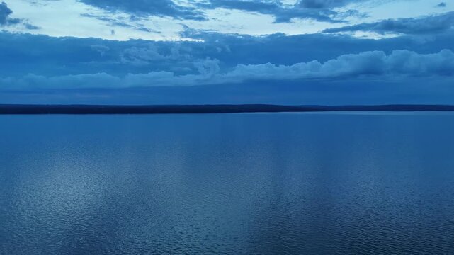 Right to Left descending Aerial of Lake Superior and Chequamegon Bay in Ashland Wisconsin.  Dramatic blue hour shot over massive horizon.