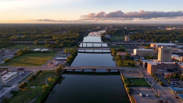 Scenic aerial flight over Genesee River in downtown Rochester New York at sunset