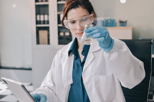 Scientists in lab coats work with plants in a modern lab, focusing on research and experimentation under bright, sterile conditions.