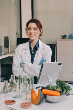 Scientists in lab coats work with plants in a modern lab, focusing on research and experimentation under bright, sterile conditions.
