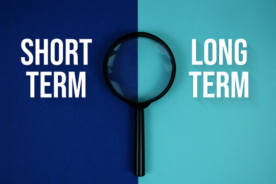 Short Term, Long Term text with magnifying glass on navy blue background