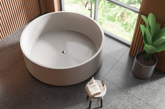 Top view of a round freestanding bathtub in a modern tropical bathroom, realistic 3D Rendering style, on a tiled floor, expressing wellness