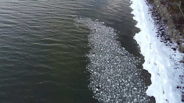 Birds Eye Ice chunks Aerial of Park off the coast of Green Bay in Winter.  Frozen Lake Michigan and snow in the midwest.