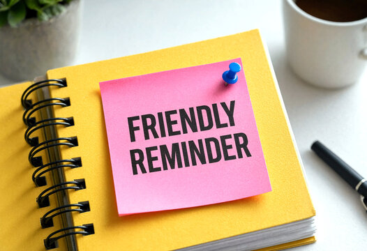 Bright sticky note with friendly reminder text on a notebook beside coffee and pen