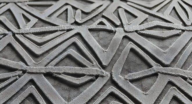 Intricate geometric patterns in a traditional metalwork design
