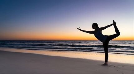 Fototapeta premium Silhouette of woman practicing yoga dancer pose at sunset on the beach