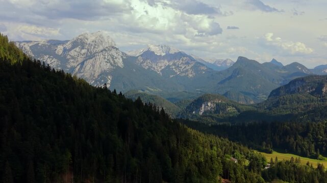 Lofer stone mountains seen from Heutal, Austrian Alps. Green alpine meadows. Aerial drone summer view