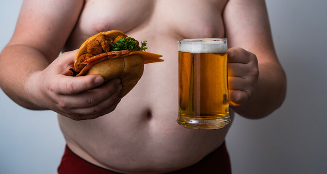 Beer belly shows overweight man. Large Beer belly shows excess weight. Beer belly signals abdominal obesity. Unhealthy Beer belly shows visceral fat.
