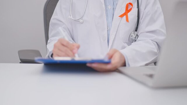Professional doctor using laptop and writing notes for February World Cancer Day, September Leukemia, March Kidney, August Appendix, Multiple Sclerosis, November CRPS and COPD disease concept
