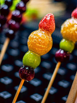 Macro Close Up of Candied Fruit Skewer with Strawberry Orange and Grape