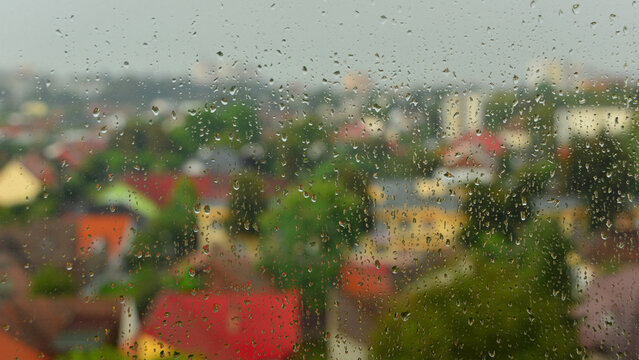 Raindrops sliding down the window pane during a violent storm of rain and wind in summer, in Targu Mures, Transylvania.