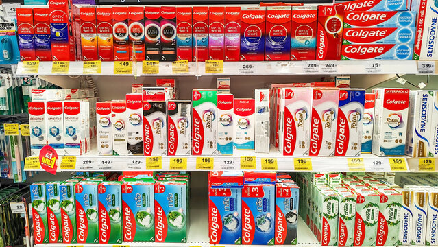 Colgate Toothpaste Display: A bright and organized retail shelf showcases a variety of Colgate toothpaste tubes and boxes, oral care product. Thailand, August 4, 2026
