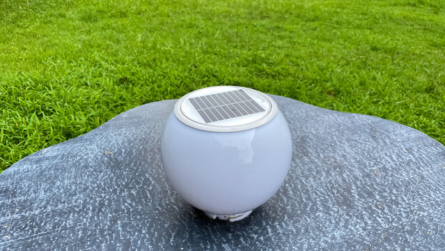 A decorative LED luminaire with a solar panel for outdoor garden or park lighting. The concept incorporates eco-friendly technologies, energy conservation, and modern landscaping.