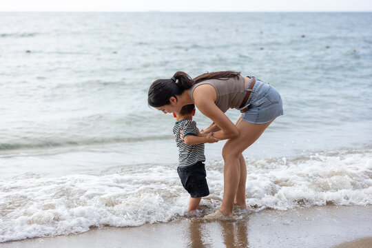 Mother and son playing on the beach
