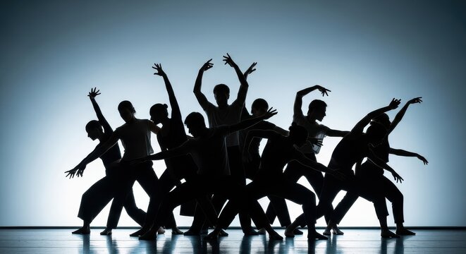 Dynamic Group of Modern Dancers in Silhouette Performing an Expressive Routine on a Lit Stage