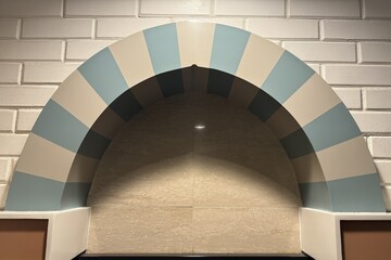 Obraz premium Modern Islamic arch niche with striped pattern against white brick wall. Mihrab architecture design in contemporary mosque or interior.