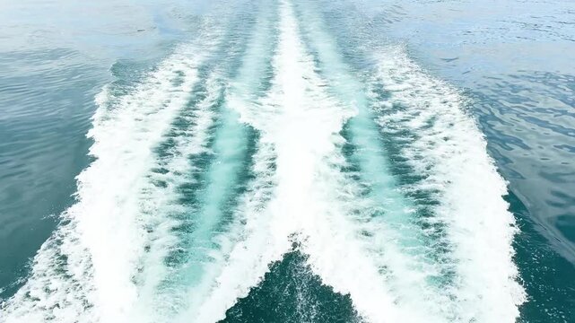 Moving yacht at the ocean with water splashes. Ocean sea water wave reflections. Motor boat in the sea	