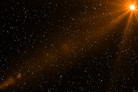 Golden Lens Flare with Falling Snow Particles on Black Background