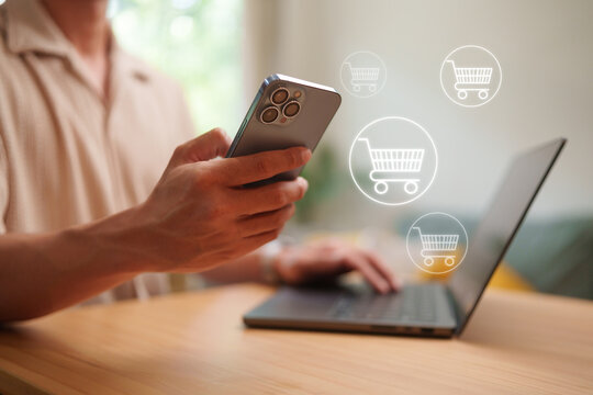 Man shopping online with smartphone and laptop, featuring digital cart icons that represent mobile commerce, secure checkout, and e-commerce convenience.