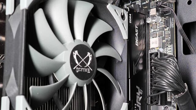 Urdorf, Switzerland, July 29, 2026. Interior of a modern PC featuring Kingston Fury RAM and ATX power connector next to a Scythe CPU cooler fan, with camera panning down