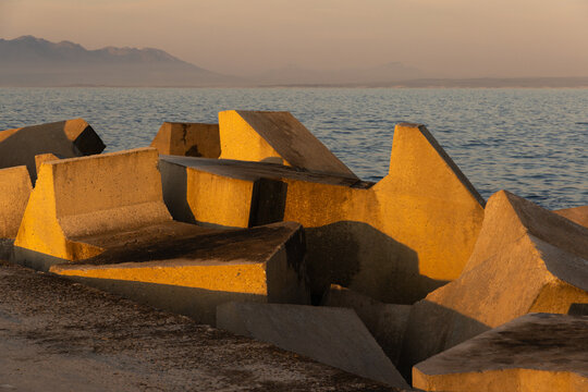distinctive concrete cubist breakwater design, new Harbor, Hermanus, South Africa at sunset and dusk