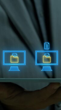 Businessman holding tablet device vertical shot displaying glowing digital document folders and data synchronization icon. High speed file transfer and folder data backup system concept.