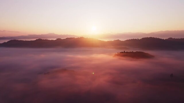 Amazing sunrise with fog move flowing over mountains,Sunrise sky,Aerial view Drone flies over clouds,Rainforest Clouds and fog in sunrise light, Nature and travel background