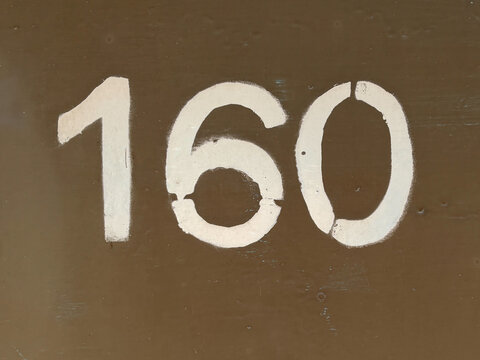 White number 160 on textured background
