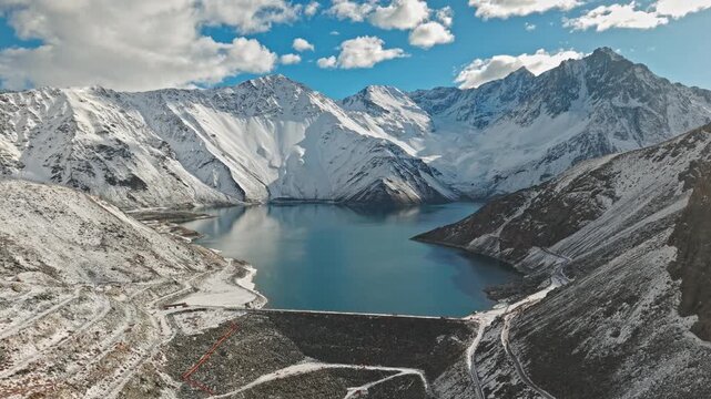 Aerial Dolly In Above El Yeso Reservoir in Snowy Andes Mountains Chile High Frame Rate Landscape