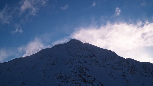 Hyperlapse of powerful blowing snow sweeping across the summit of Mont Gel&eacute; in Verbier 4 Vall&eacute;es, Switzerland, during strong alpine winter winds.