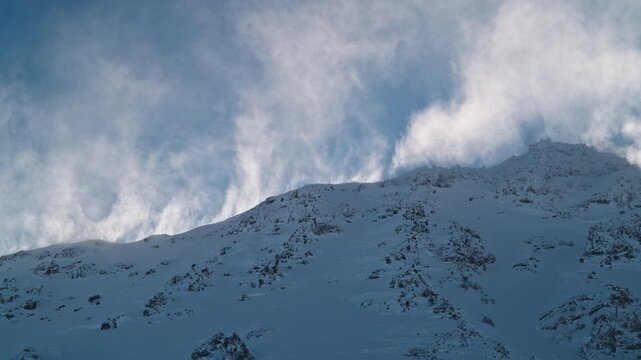 Powerful blowing snow sweeping across the summit of Mont Gel&eacute; in Verbier 4 Vall&eacute;es, Switzerland, during strong alpine winds.