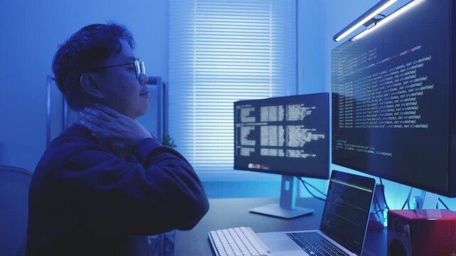 Programmer Stretching at Desk to Prevent Office Syndrome, Wellness in Technology.