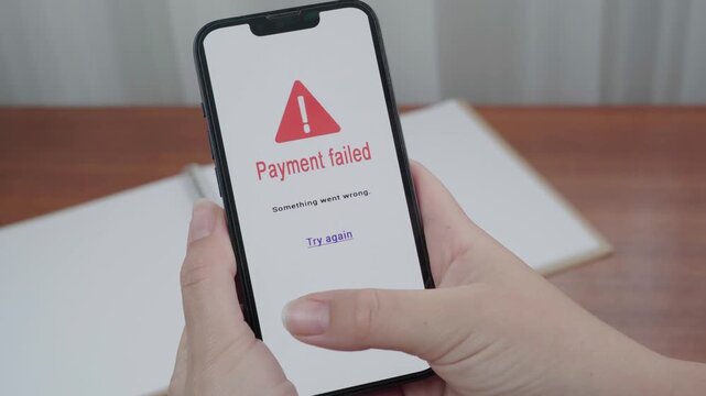 Hands hold a phone displaying an AI payment failed error with a red warning icon and a try again link.