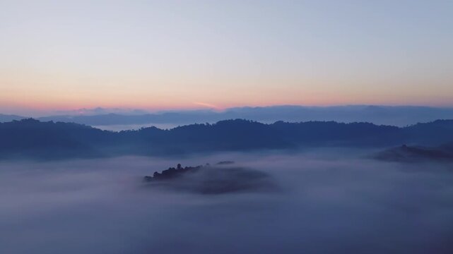 Amazing sunrise with fog move flowing over mountains,Sunrise sky,Aerial view Drone flies over clouds,Rainforest Clouds and fog in sunrise light, Nature and travel background