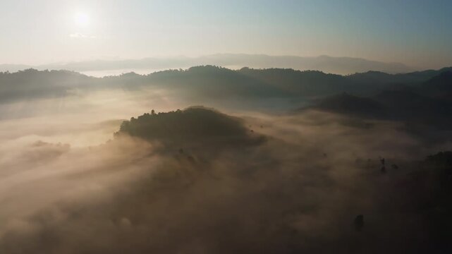 Amazing sunrise with fog move flowing over mountains,Sunrise sky,Aerial view Drone flies over clouds,Rainforest Clouds and fog in sunrise light, Nature and travel background