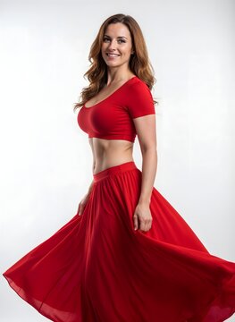 Full-body portrait of a confident 35-year-old Caucasian woman in a red crop top and flowing skirt, showcasing a defined waist and subtly enhanced silhouette, symbolizing successful aesthetic surgery a