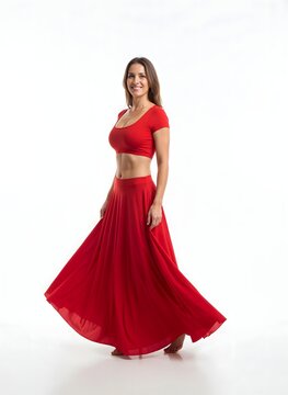 Full-body portrait of a confident 35-year-old Caucasian woman in a red crop top and flowing skirt, showcasing a defined waist and subtly enhanced silhouette, symbolizing successful aesthetic surgery a