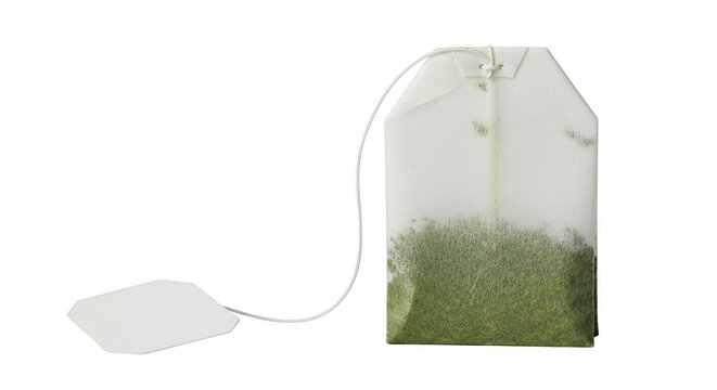Single green tea bag with paper tag on a string isolated on transparent background