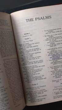 Kuala Lumpur, Malaysia - July 22nd, 2026: Opening to the Book of The Psalms of the Old Testament in the Holy Bible. New Revised Standard Version. Vertical video.
